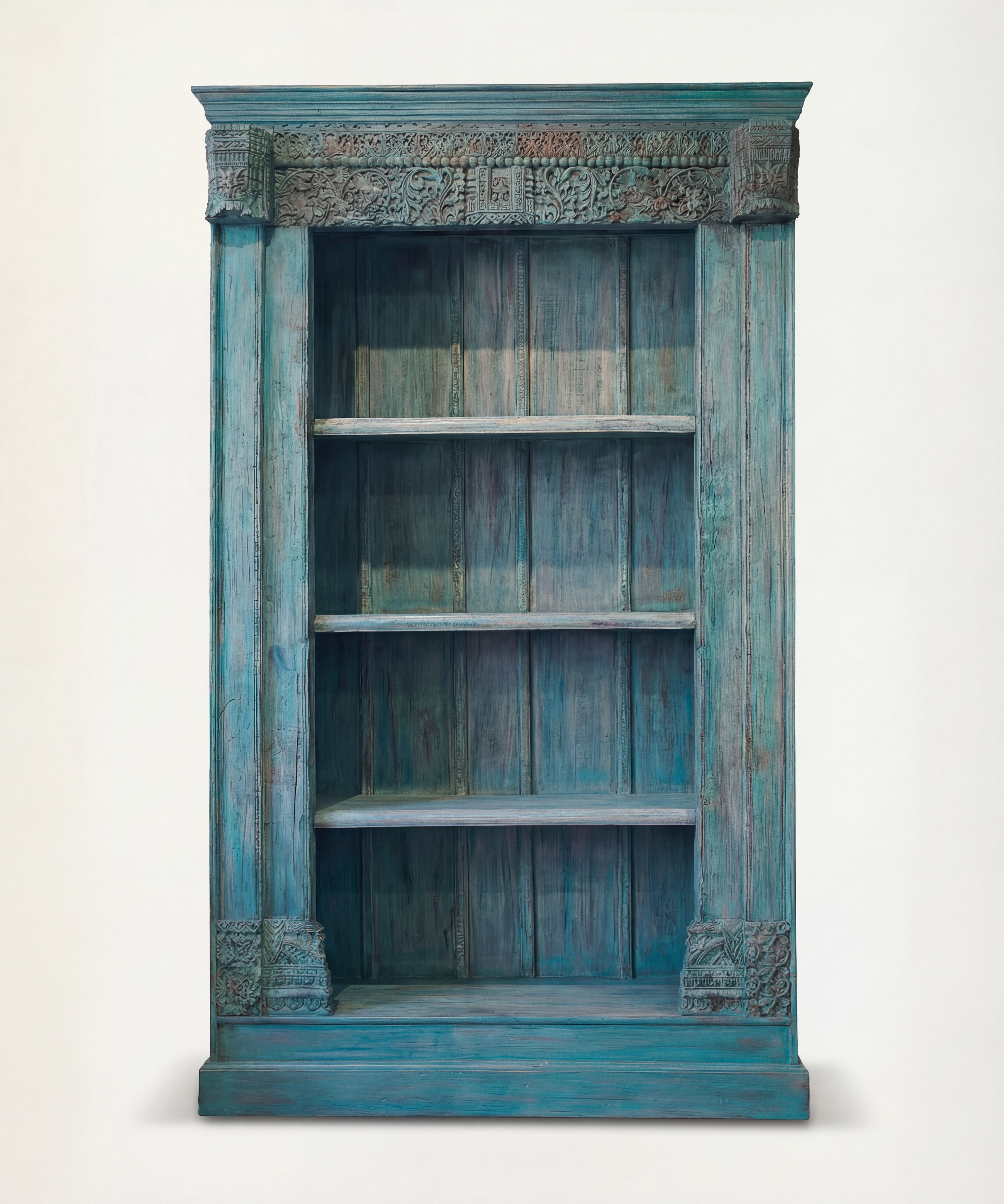 Blue distressed bookshelf with decorative elements on a white background