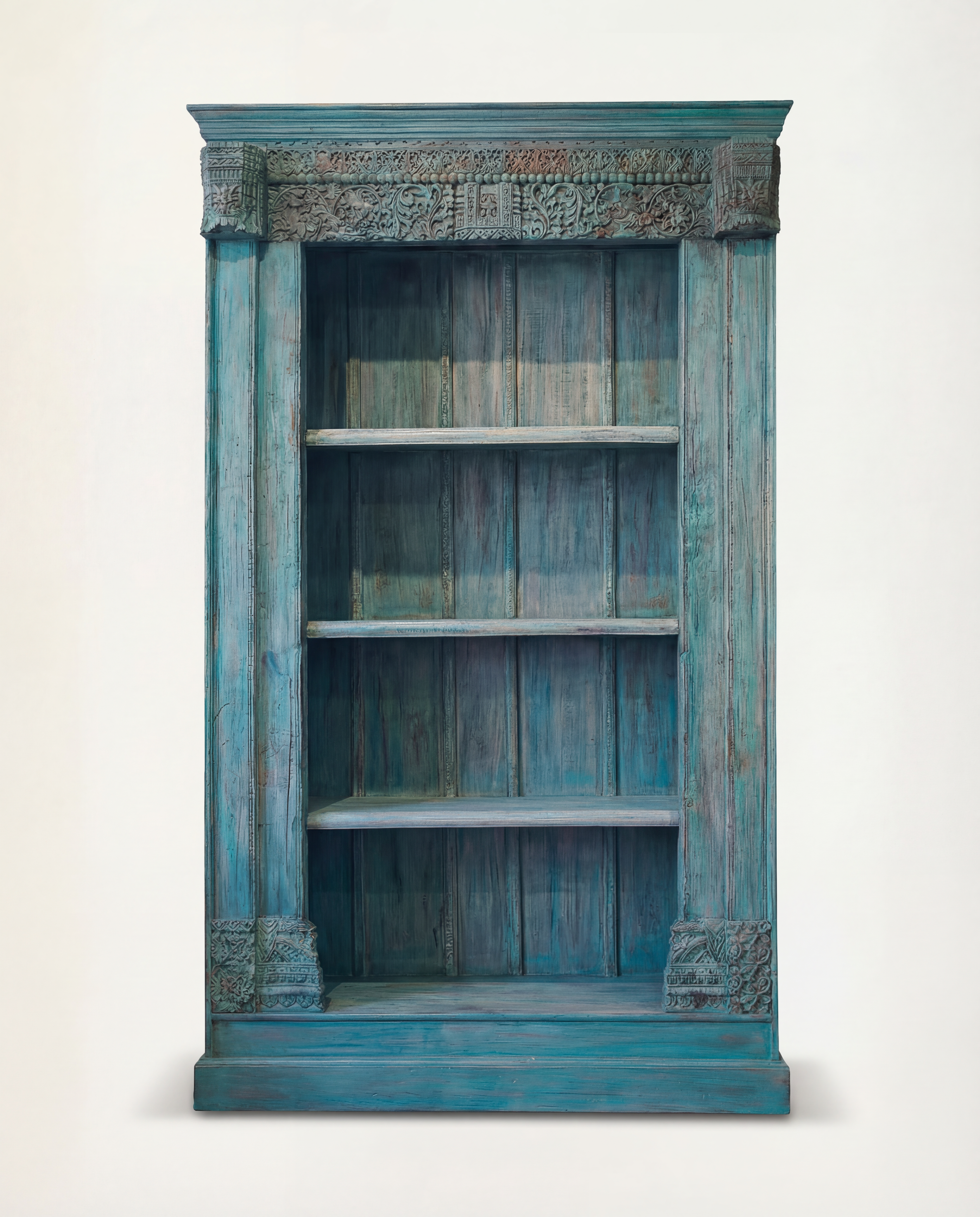 Blue distressed bookshelf with decorative elements on a white background