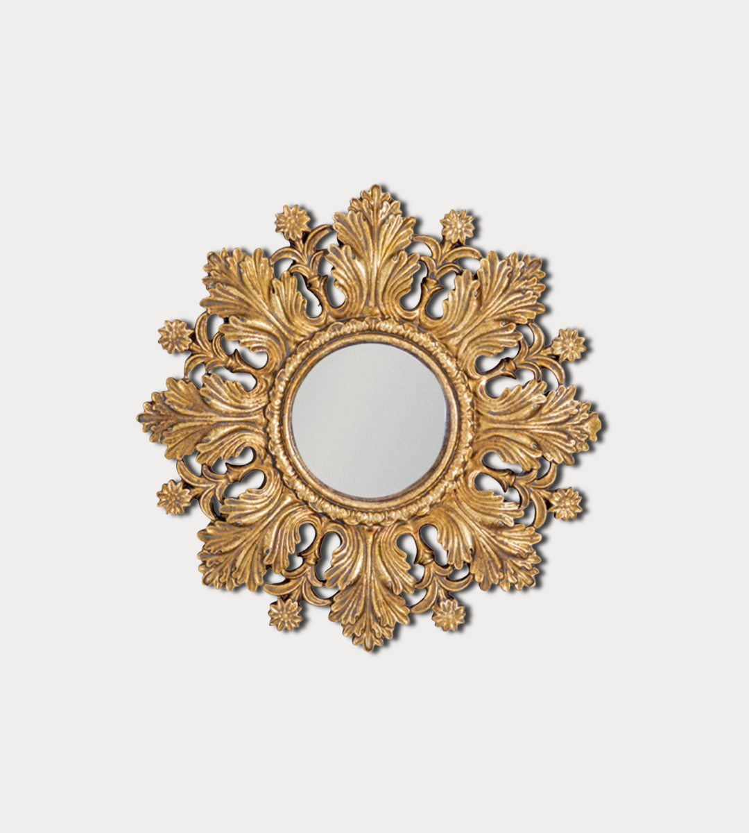 Decorative gold mirror with intricate patterns on a light gray background
