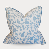 Decorative pillow with blue floral pattern on a white background