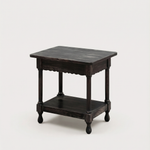 Dark wooden side table on a beige background