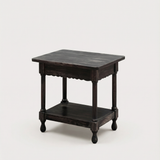 Dark wooden side table on a beige background