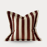 Striped pillow with brown and beige pattern on a white background