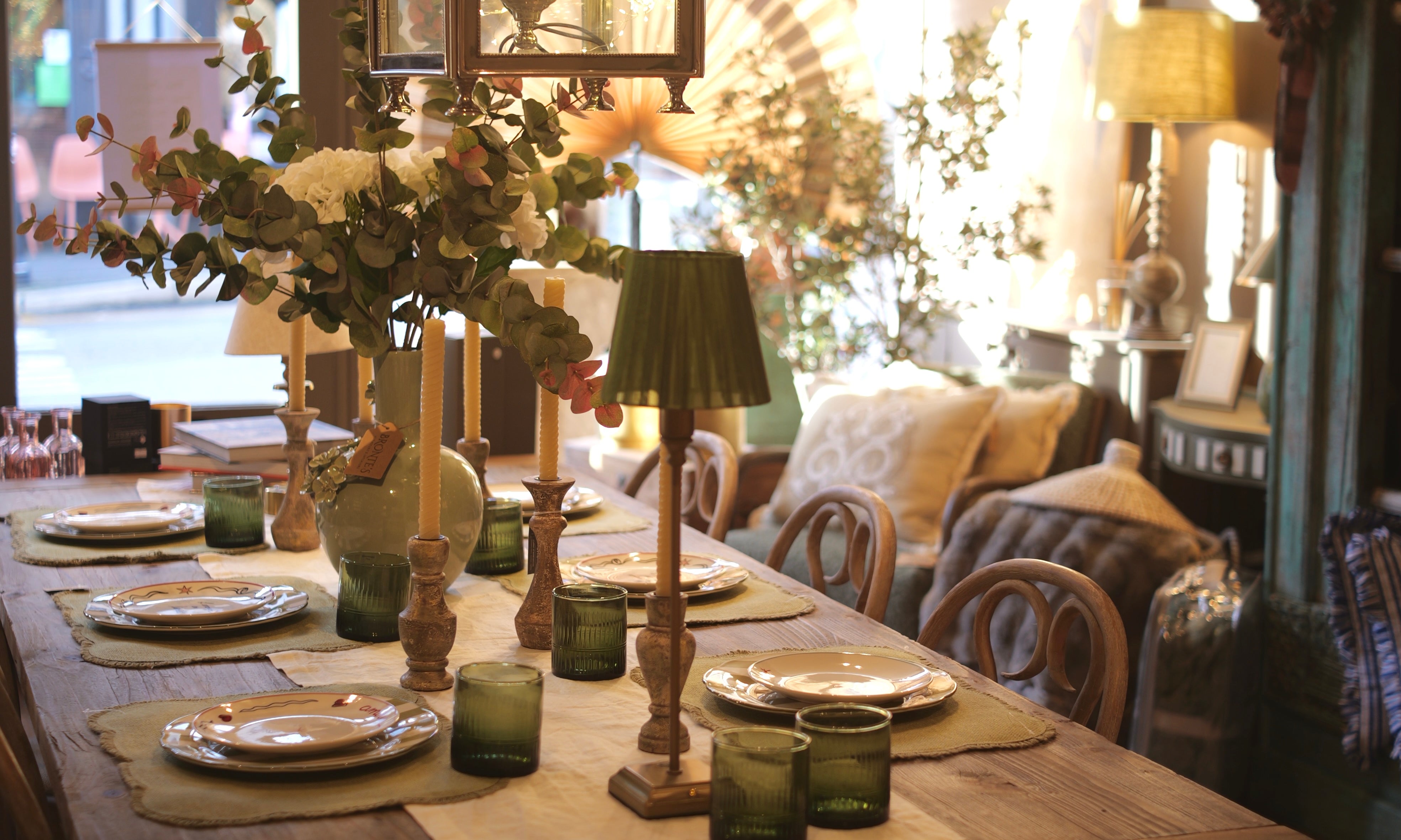 Dining room with wooden table set for a meal, decorative elements, and a cozy atmosphere.