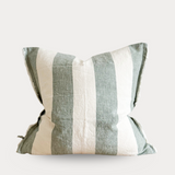 Striped pillow with green and beige pattern on a white background
