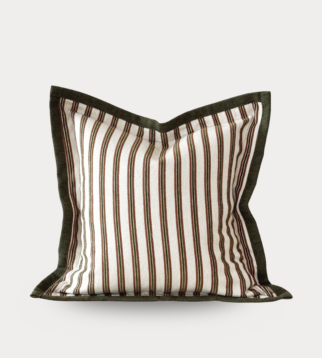 Striped pillow with brown and white pattern on a light gray background