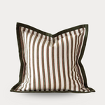 Striped pillow with brown and white pattern on a light gray background