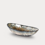 Decorative bowl with a metallic finish on a light gray background