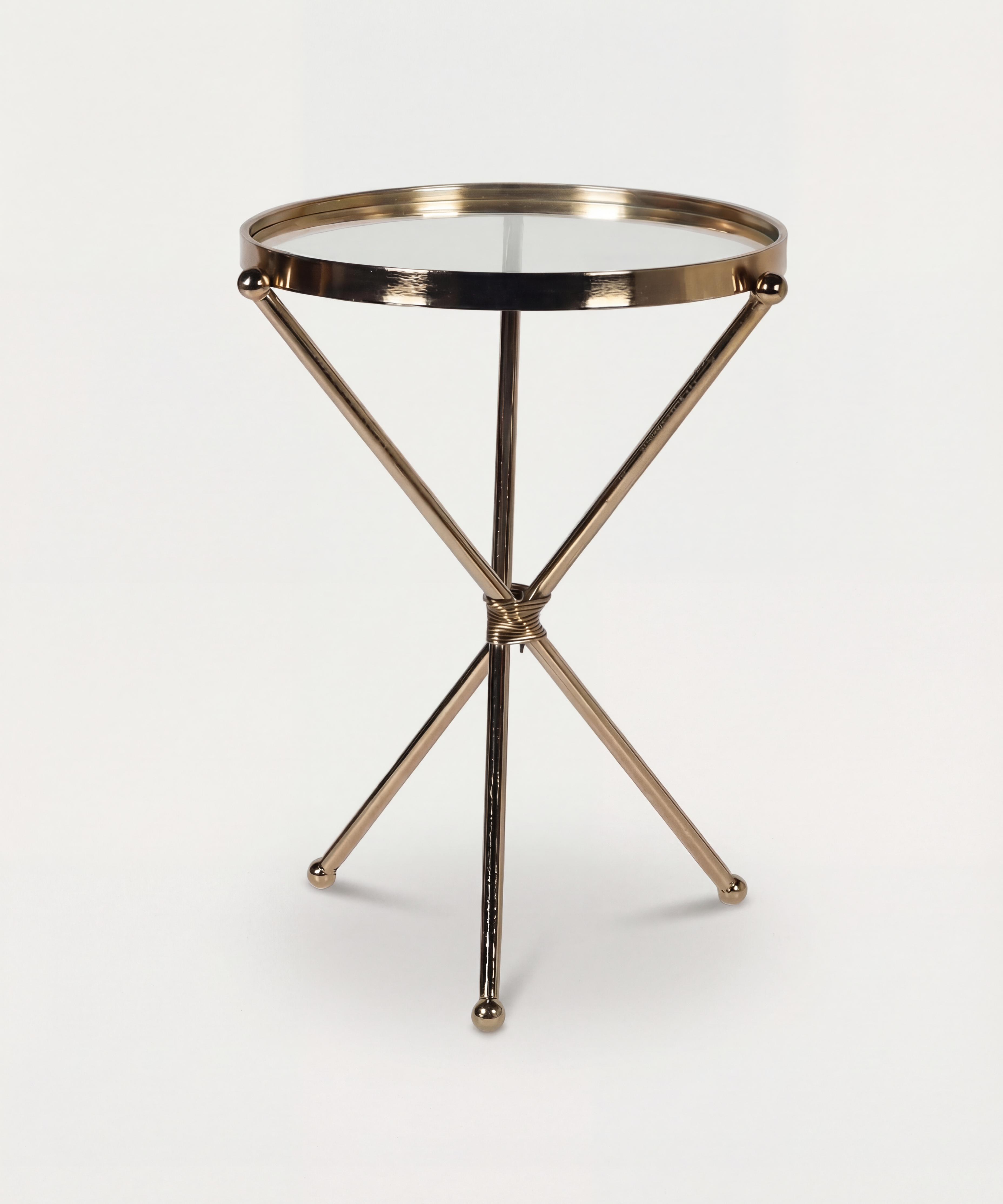 Small round table with a metallic gold base on a white background