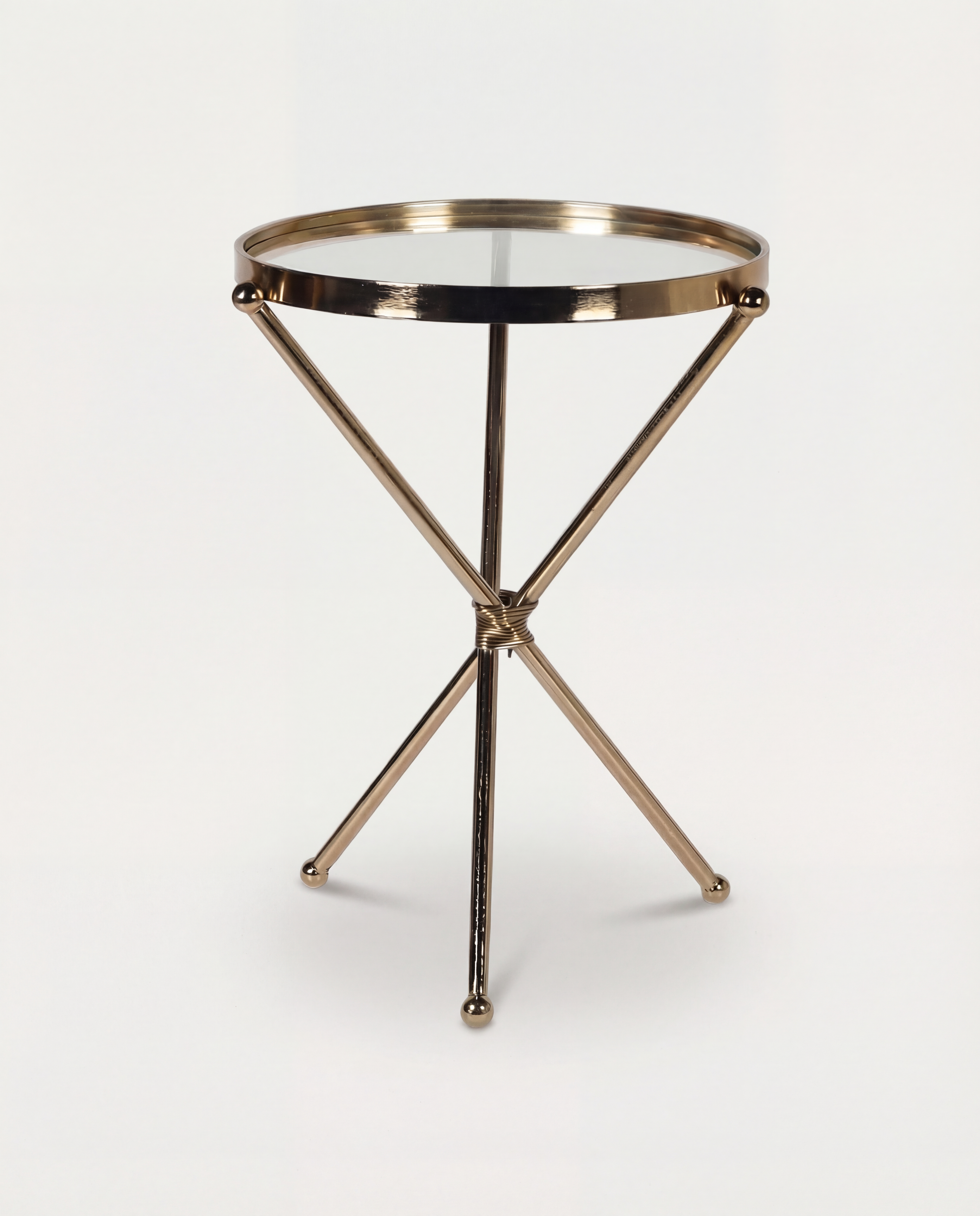 Small round table with a metallic gold base on a white background