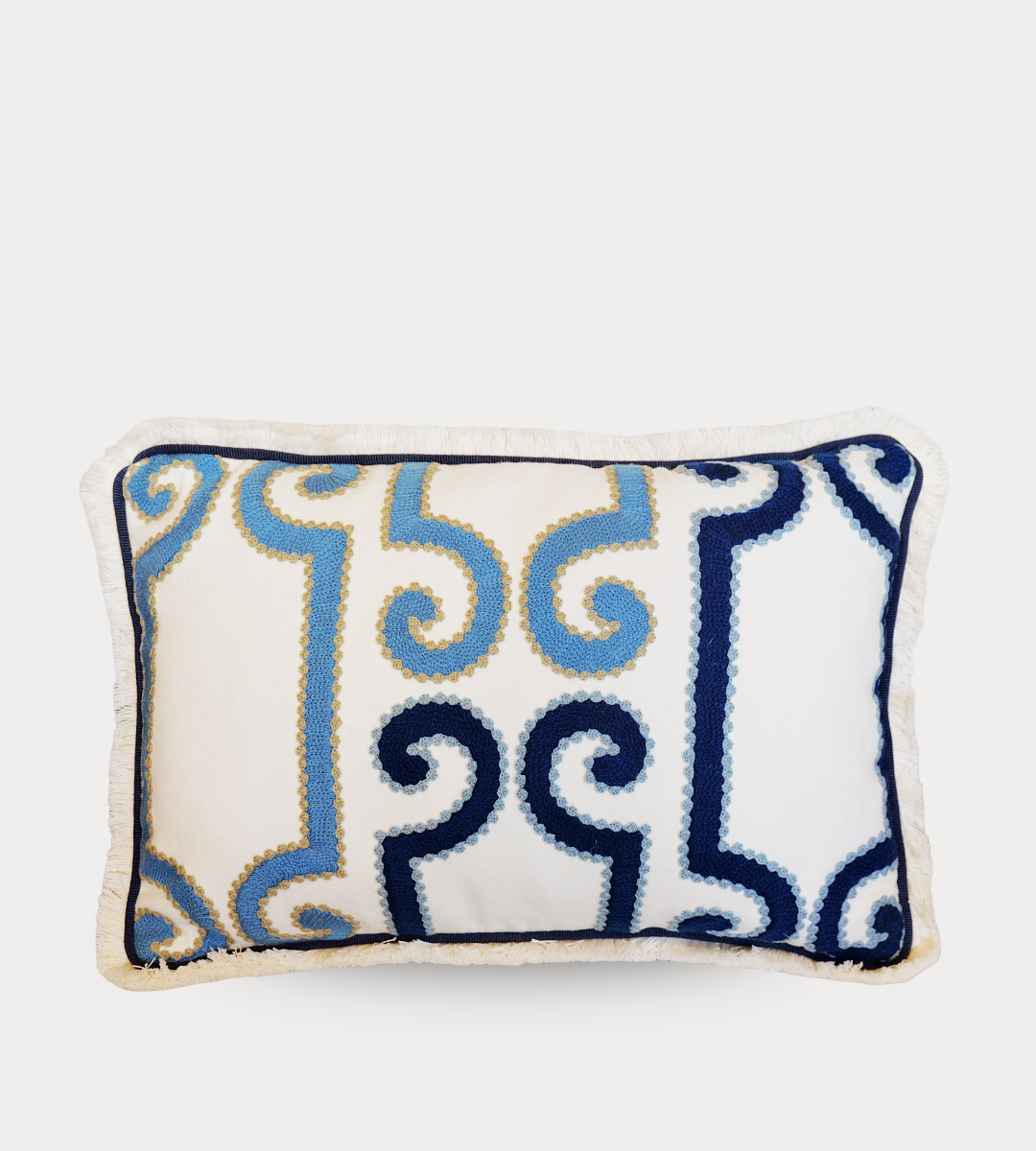 Decorative pillow with blue and navy pattern on a white background