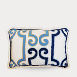 Decorative pillow with blue and navy pattern on a white background