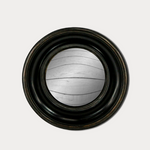 Round mirror with a black frame on a light gray background