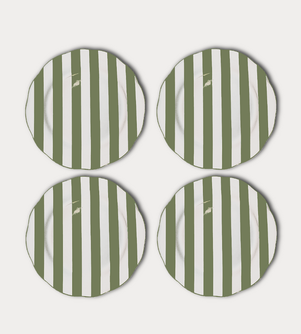 Four green and white striped plates on a light gray background