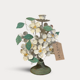 Decorative metal tree with flowers and a tag on a white background