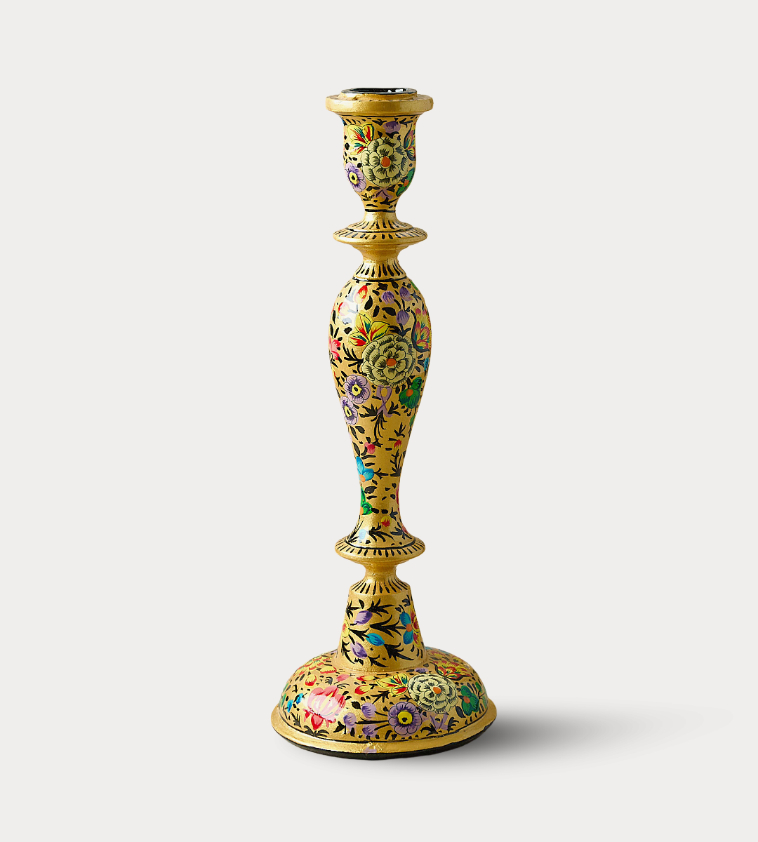Decorative candle holder with floral patterns on a white background