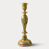 Decorative candle holder with floral patterns on a white background