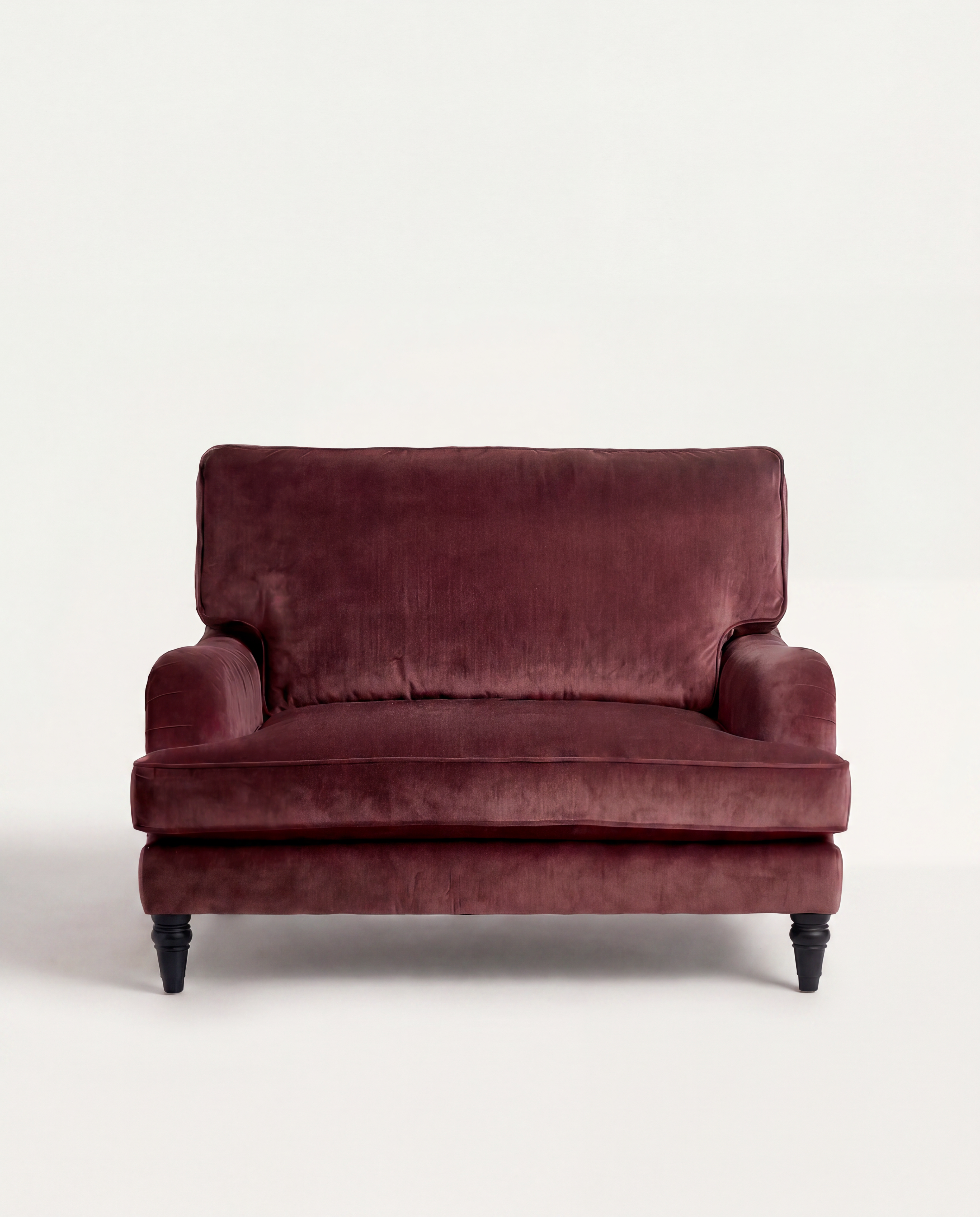 Maroon velvet sofa on a white background