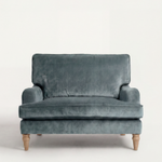 Blue velvet sofa on a white background