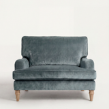 Blue velvet sofa on a white background