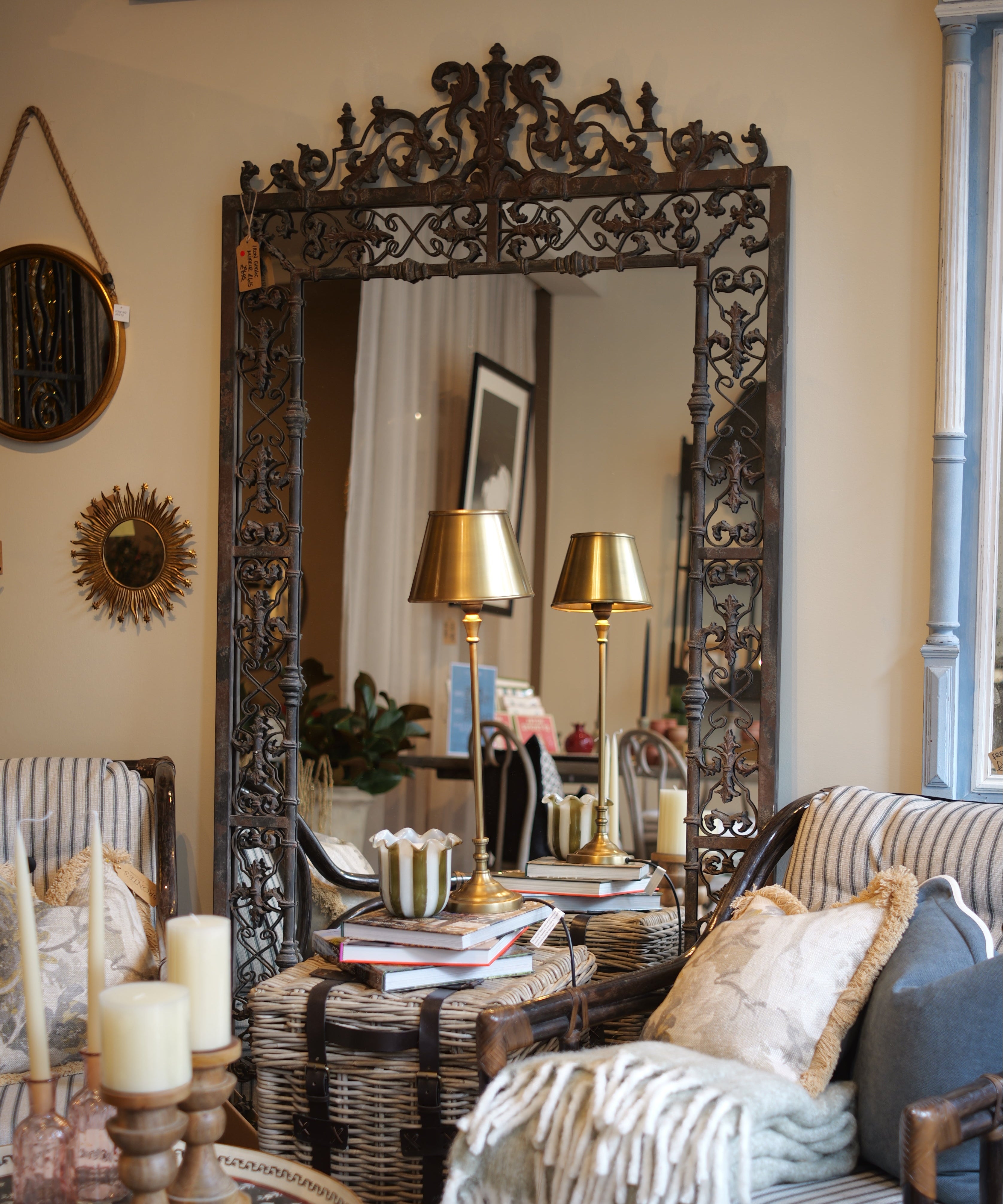 Living room with ornate mirror, striped sofa, and decorative pillows.