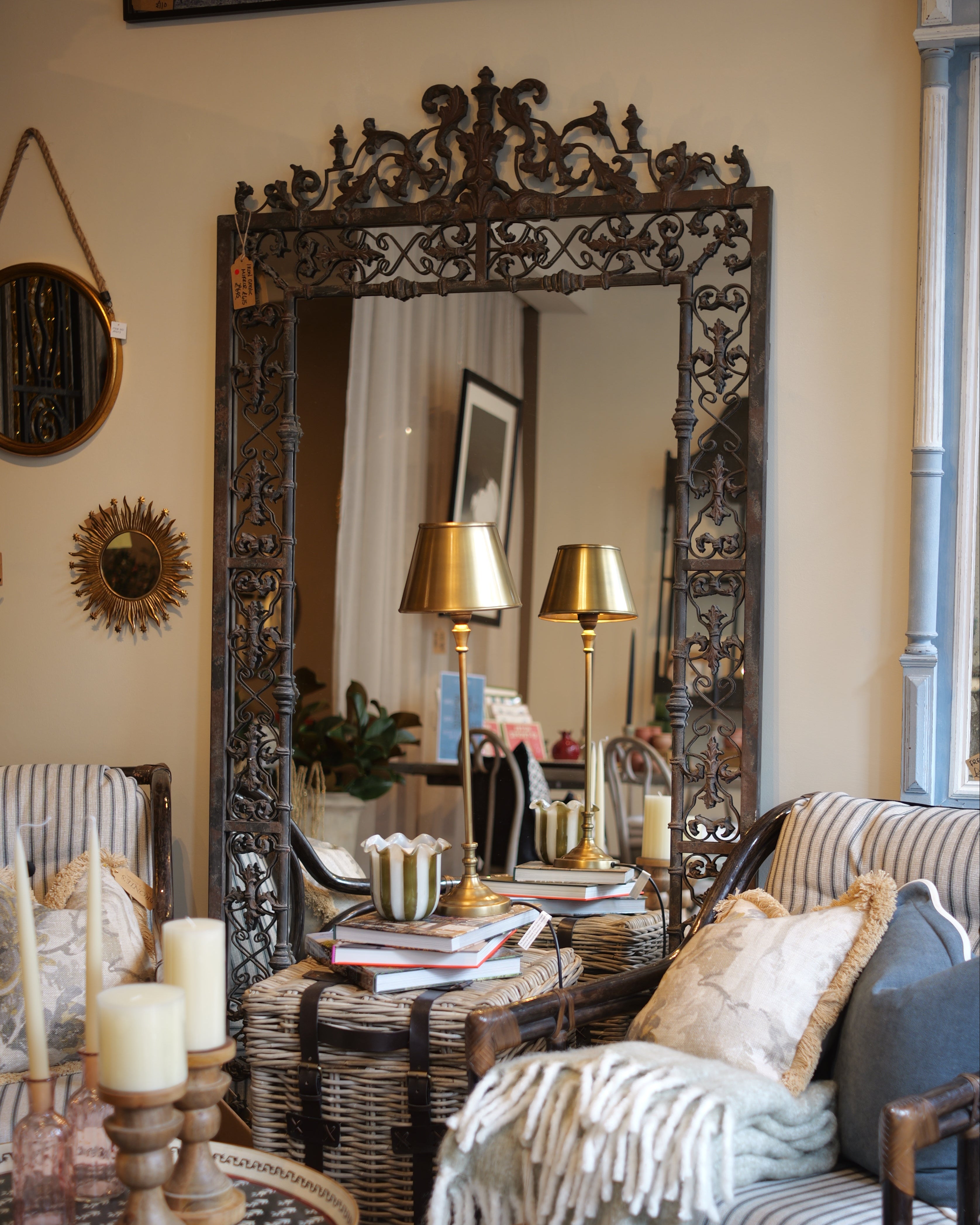 Living room with ornate mirror, striped sofa, and decorative pillows.