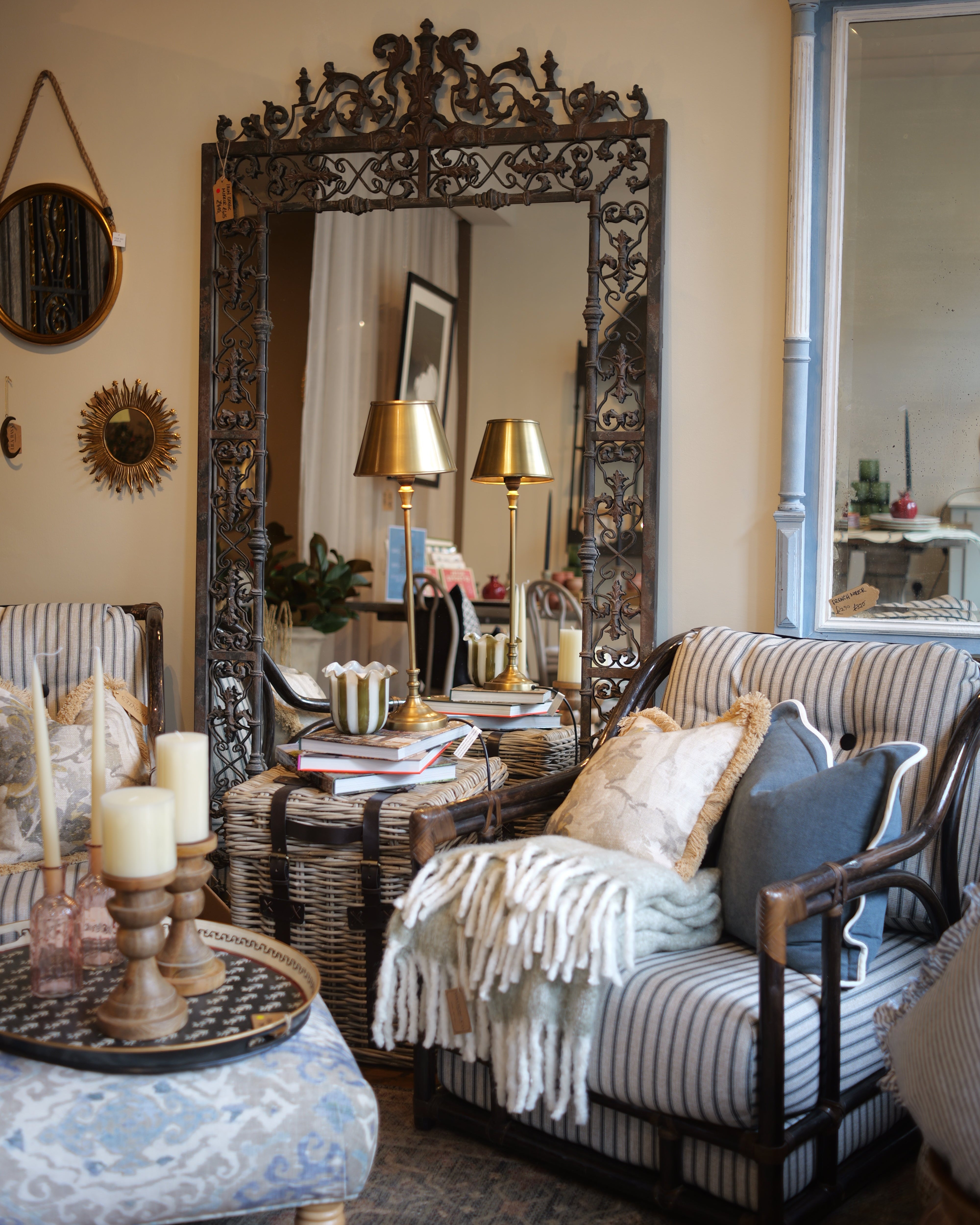 Living room with ornate mirror, striped sofa, and decorative pillows.